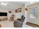 Cozy living room featuring a rocking chair, recliner, and a large TV at 134 Avalon Dr # A, Ormond Beach, FL 32176