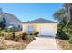 Cute yellow house with a white garage door and well-manicured landscaping at 134 Avalon Dr # A, Ormond Beach, FL 32176