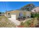 Newly constructed light yellow home with a gray roof, white shutters, and a landscaped front yard at 134 Avalon Dr # A, Ormond Beach, FL 32176
