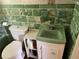Retro bathroom with green tile and vintage vanity at 2202 Lake Ruby Rd, Deland, FL 32724