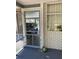 Screened porch with brick wall and a view to the carport at 2202 Lake Ruby Rd, Deland, FL 32724
