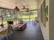 Large screened porch with rocking chairs and outdoor furniture at 2202 Lake Ruby Rd, Deland, FL 32724