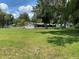 Spacious front yard with mature trees and a single-story home at 2202 Lake Ruby Rd, Deland, FL 32724