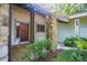 Charming front porch with stone pillars and a wooden deck at 121 Willow Bend Ln, Ormond Beach, FL 32174