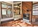 Living room with wood-burning fireplace, built-in shelving, and hardwood floors at 121 Willow Bend Ln, Ormond Beach, FL 32174