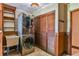 Laundry room with stackable washer/dryer, utility sink, and wood-paneled walls at 121 Willow Bend Ln, Ormond Beach, FL 32174