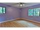 Spacious bedroom with light purple walls and wood-look laminate flooring at 121 Willow Bend Ln, Ormond Beach, FL 32174