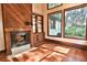 Cozy living room with wood-burning fireplace, built-in shelving, and hardwood floors at 121 Willow Bend Ln, Ormond Beach, FL 32174
