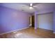 Bedroom with light purple walls, wood-look laminate flooring, and a walk-in closet at 121 Willow Bend Ln, Ormond Beach, FL 32174
