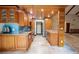 Modern kitchen with wood cabinets, granite counters, and tile backsplash at 121 Willow Bend Ln, Ormond Beach, FL 32174