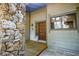Inviting front entrance with a stone accent wall and wooden door at 121 Willow Bend Ln, Ormond Beach, FL 32174