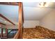 Upstairs loft area with wood beams and neutral carpeting at 121 Willow Bend Ln, Ormond Beach, FL 32174