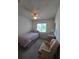 Bright bedroom with a twin bed, chair, and window overlooking a garden at 833 E 22Nd Ave, New Smyrna Beach, FL 32169