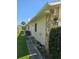 Side yard view showing house exterior and landscaping at 833 E 22Nd Ave, New Smyrna Beach, FL 32169