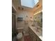 Bathroom with skylight, toilet, and vanity with double sinks at 833 E 22Nd Ave, New Smyrna Beach, FL 32169