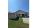 Backyard view showing patio, shed, and house exterior at 833 E 22Nd Ave, New Smyrna Beach, FL 32169