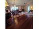 Spacious living room with hardwood floors, stone fireplace, and ample natural light at 833 E 22Nd Ave, New Smyrna Beach, FL 32169