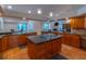 Spacious kitchen with island, granite countertops, and wood cabinets at 1839 Spruce Creek Blvd, Port Orange, FL 32128