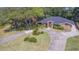 Aerial view of a single-Gathering home with a large yard and circular driveway at 1839 Spruce Creek Blvd, Port Orange, FL 32128