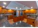 Spacious kitchen featuring granite countertops and wood cabinetry at 1839 Spruce Creek Blvd, Port Orange, FL 32128