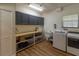 Laundry room with washer, dryer, cabinets and ample storage at 1839 Spruce Creek Blvd, Port Orange, FL 32128