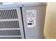 Close-up view of the AC unit's information sticker at 196 Athabasca Dr, Poinciana, FL 34759