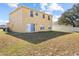 Two-story home with fenced backyard and sliding glass doors at 196 Athabasca Dr, Poinciana, FL 34759