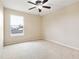 Empty bedroom with neutral walls, carpeting, ceiling fan, and window at 196 Athabasca Dr, Poinciana, FL 34759