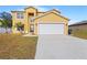 Attractive two-story home with a double garage and landscaped front yard at 196 Athabasca Dr, Poinciana, FL 34759