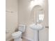 Clean half-bathroom with pedestal sink and oval mirror at 196 Athabasca Dr, Poinciana, FL 34759