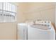 Convenient laundry room with washer, dryer, and storage shelf at 196 Athabasca Dr, Poinciana, FL 34759