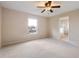 Spacious main bedroom with carpeting, ceiling fan, and ensuite bathroom access at 196 Athabasca Dr, Poinciana, FL 34759