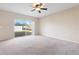 Large main bedroom with carpet, ceiling fan, and sliding glass doors at 196 Athabasca Dr, Poinciana, FL 34759