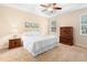 Spacious Primary bedroom with king-size bed and ceiling fan at 509 W Victoria Trails Blvd, Deland, FL 32724