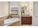 Bathroom with corner soaking tub and granite vanity at 509 W Victoria Trails Blvd, Deland, FL 32724