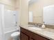 Clean bathroom with granite countertop, shower, and bathtub at 509 W Victoria Trails Blvd, Deland, FL 32724