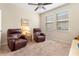Relaxing sitting room with two leather recliners and ceiling fan at 509 W Victoria Trails Blvd, Deland, FL 32724