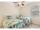 Guest bedroom with twin beds and ceiling fan at 509 W Victoria Trails Blvd, Deland, FL 32724
