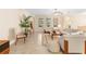 Spacious living room with light beige sofas, wooden coffee table, and large windows at 509 W Victoria Trails Blvd, Deland, FL 32724