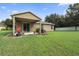 Covered patio and spacious grassy backyard at 968 Springs Landing Dr, Deltona, FL 32725