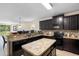 Modern kitchen with island, ample counter space, and dark wood cabinets at 968 Springs Landing Dr, Deltona, FL 32725