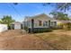 Gray house with white accents, a screened porch, and a detached garage at 151 S Ridgewood Ave, Ormond Beach, FL 32174