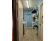 Laundry room with washer, dryer, and storage shelves at 24008 Ermine Rd, Astor, FL 32102