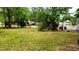 Large grassy front yard with mature trees at 24008 Ermine Rd, Astor, FL 32102