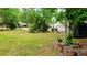 Spacious front yard with lush grass and trees at 24008 Ermine Rd, Astor, FL 32102