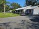 Single-story home with paved driveway and fenced yard at 24008 Ermine Rd, Astor, FL 32102