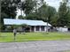 Single story home with metal roof and fenced yard at 24008 Ermine Rd, Astor, FL 32102