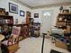 Living room with bookcases, rocking chair, and treadmill at 24008 Ermine Rd, Astor, FL 32102