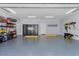 Spacious garage with overhead storage and epoxy flooring at 717 Ocean Shore Blvd, Ormond Beach, FL 32176