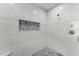 Large walk-in shower with hexagon tile floor and niche at 717 Ocean Shore Blvd, Ormond Beach, FL 32176